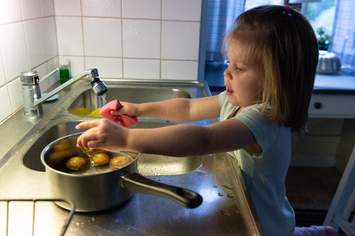 Izadora hjälper till att tvätta potatisen